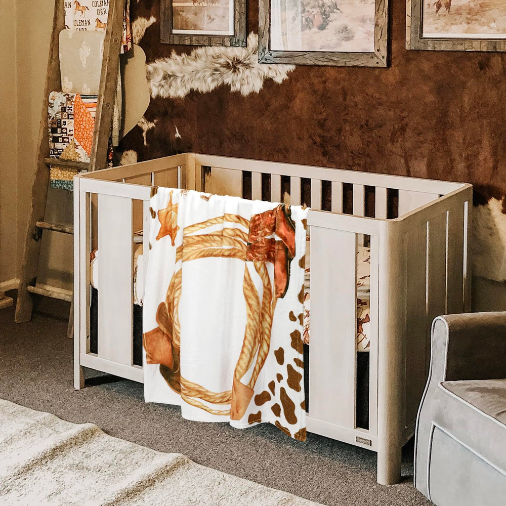 Gicoherero Cowboy Print Blanket used as versatile prop for swaddle, play, and cuddling