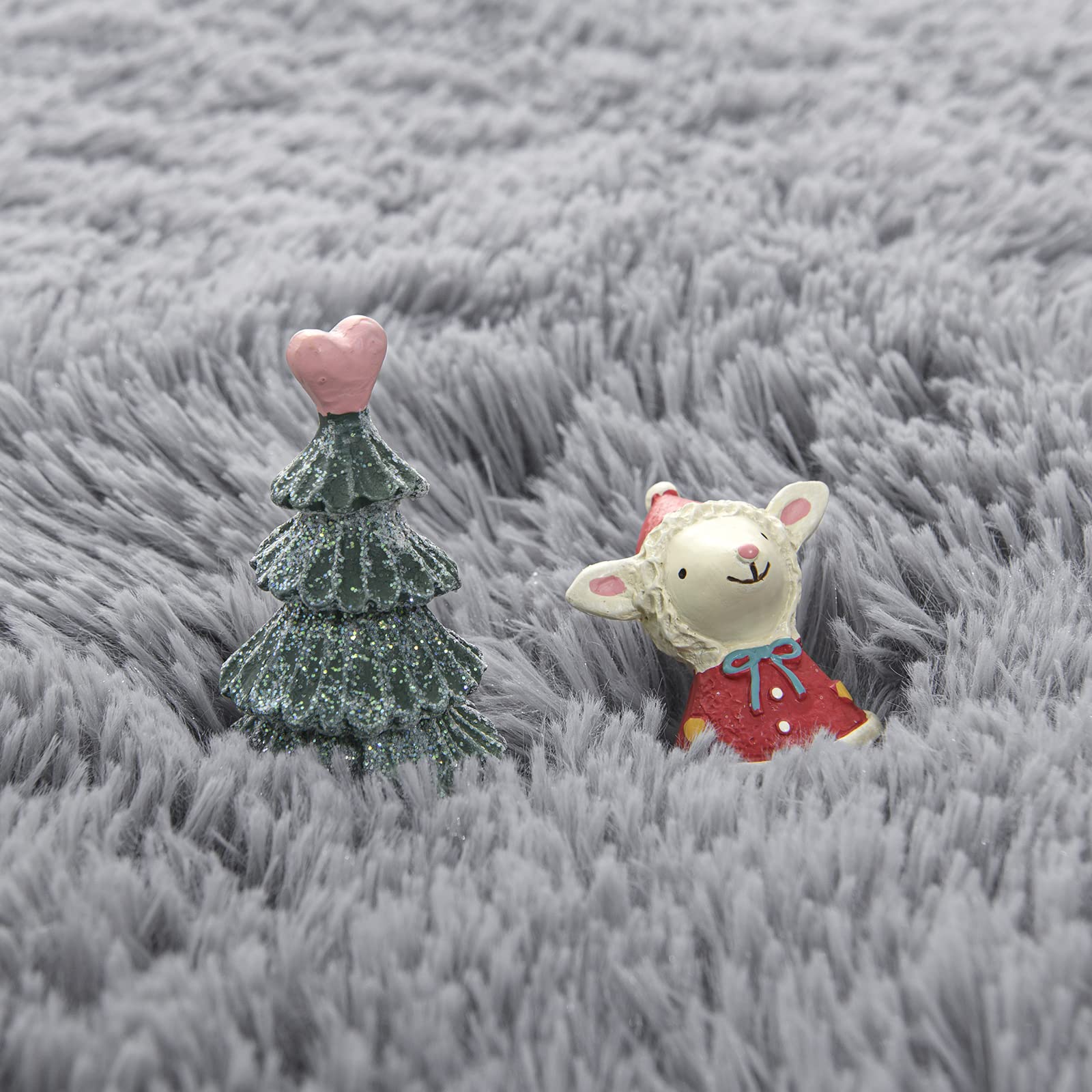 Gifeas grey fluffy circle rug in a kid's room adding warmth and charm.