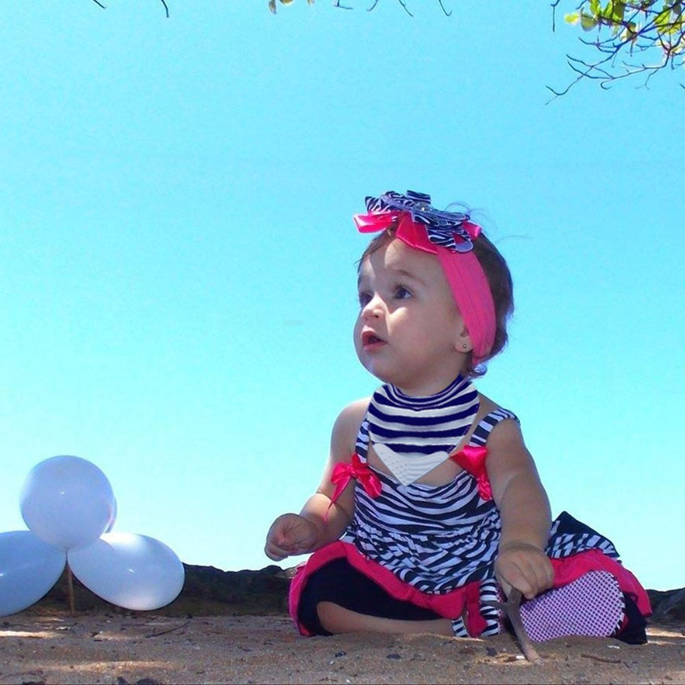 Giftty teething bib worn by baby during snack time for drool control.