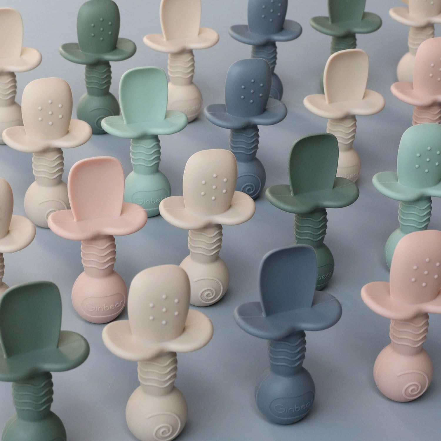 Ginbear pack of four spoons in hazy green and pink.
