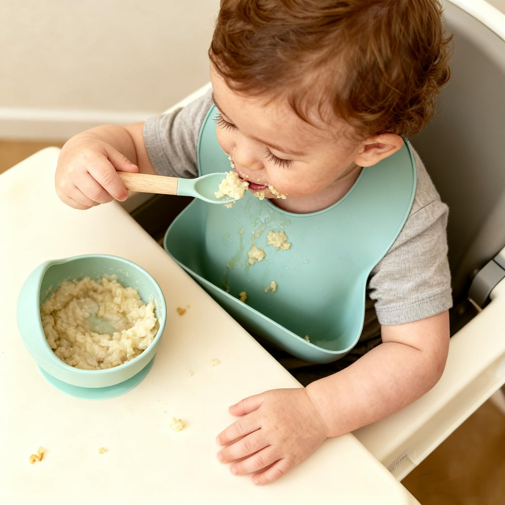 Ginbear silicone bowl raised edge helps guide food and reduce spills.