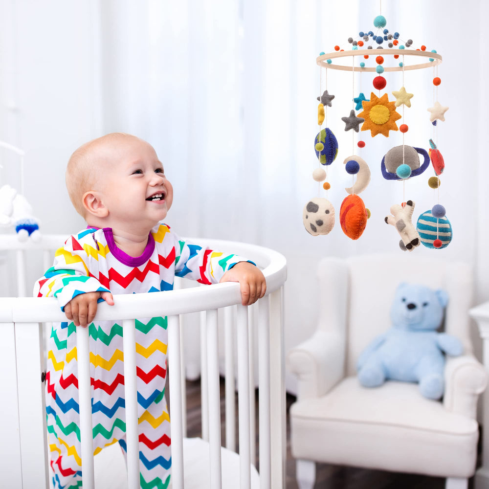 Glaciart One space nursery mobile starry backdrop stimulates bedtime imagination.