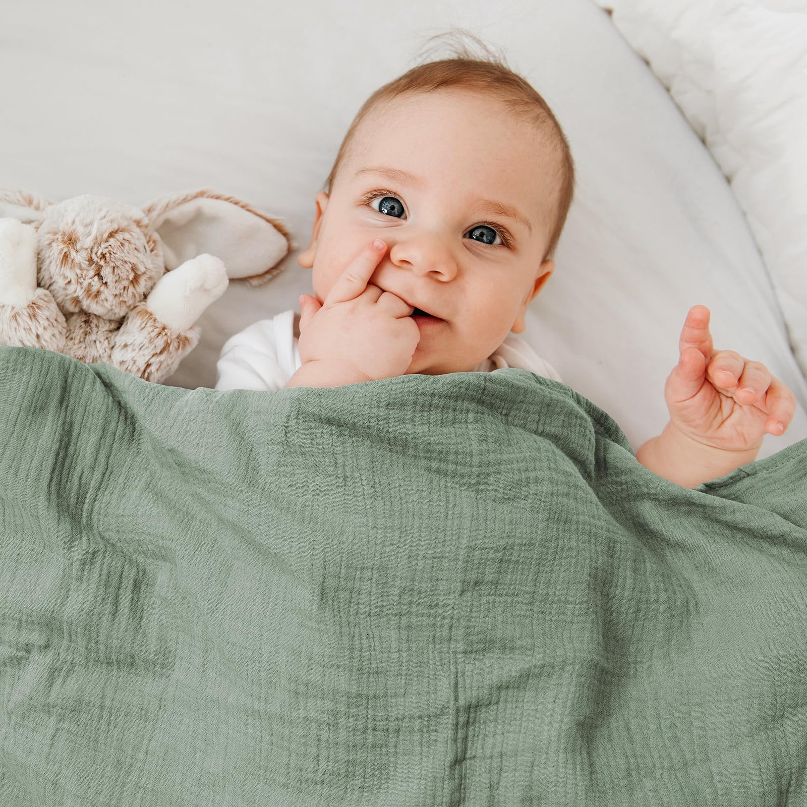 GLLQUEN BABY swaddled infant wrapped in muslin swaddle blanket