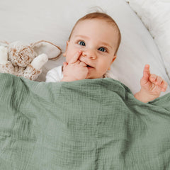 GLLQUEN BABY swaddled infant wrapped in muslin swaddle blanket