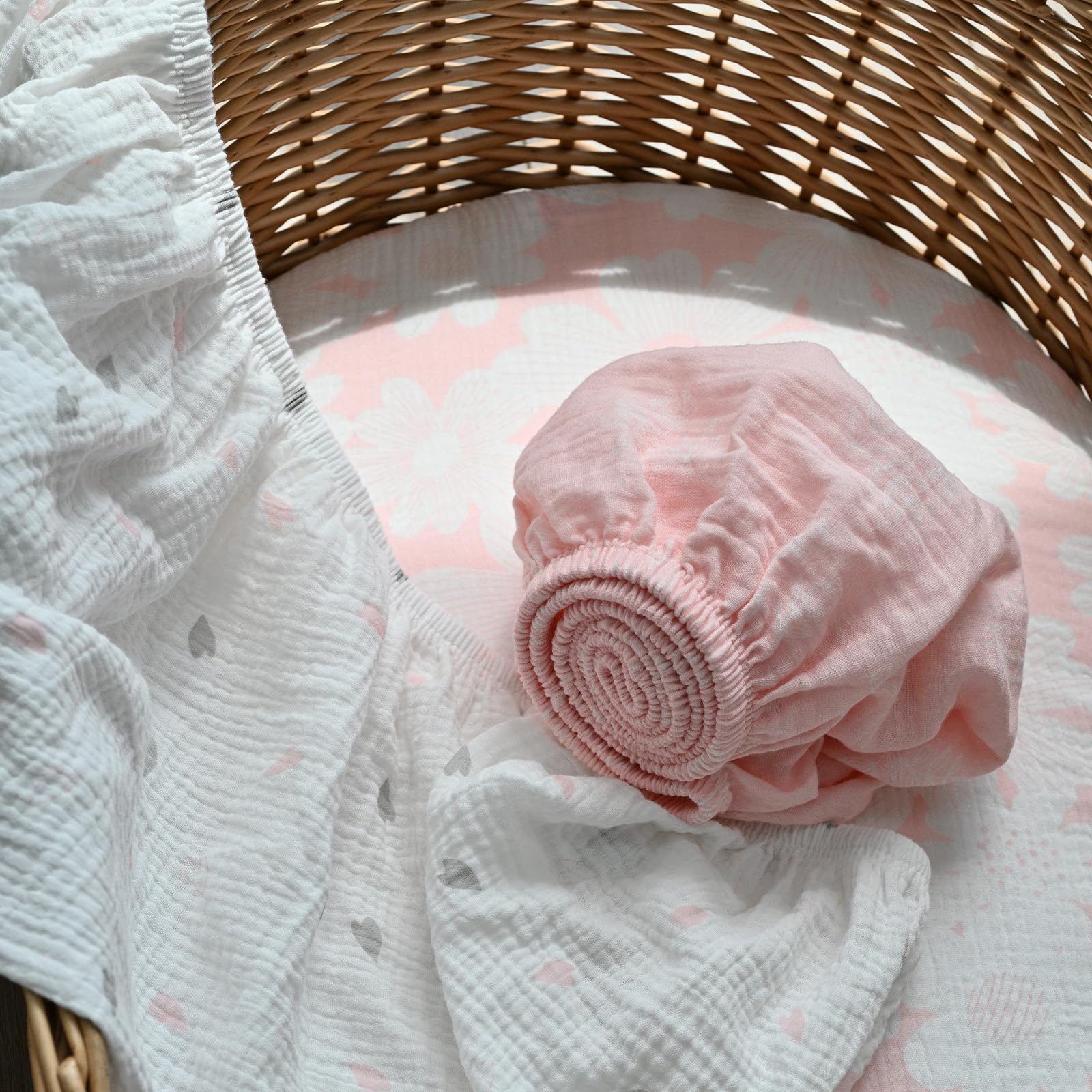 Gllquen bassinet sheets with elastic edge for snug fit demonstration.