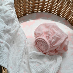 Gllquen bassinet sheets with elastic edge for snug fit demonstration.