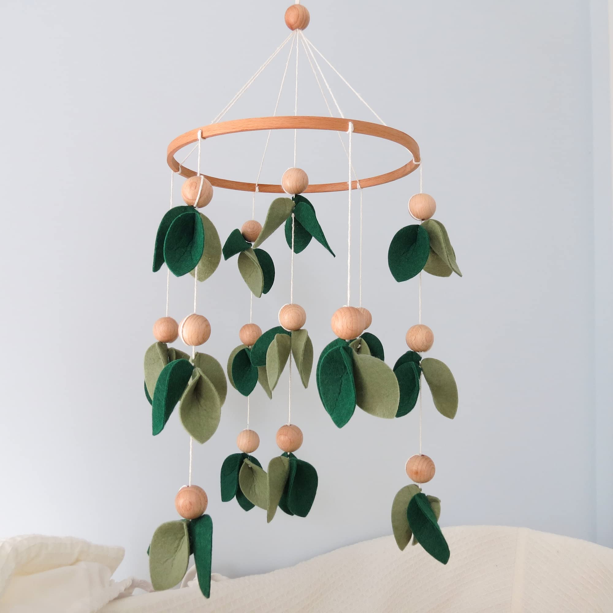 Goukurlsma baby mobile with leaves and wooden beads for decorative yet stimulating play.