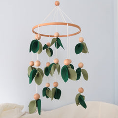 Goukurlsma baby mobile with leaves and wooden beads for decorative yet stimulating play.