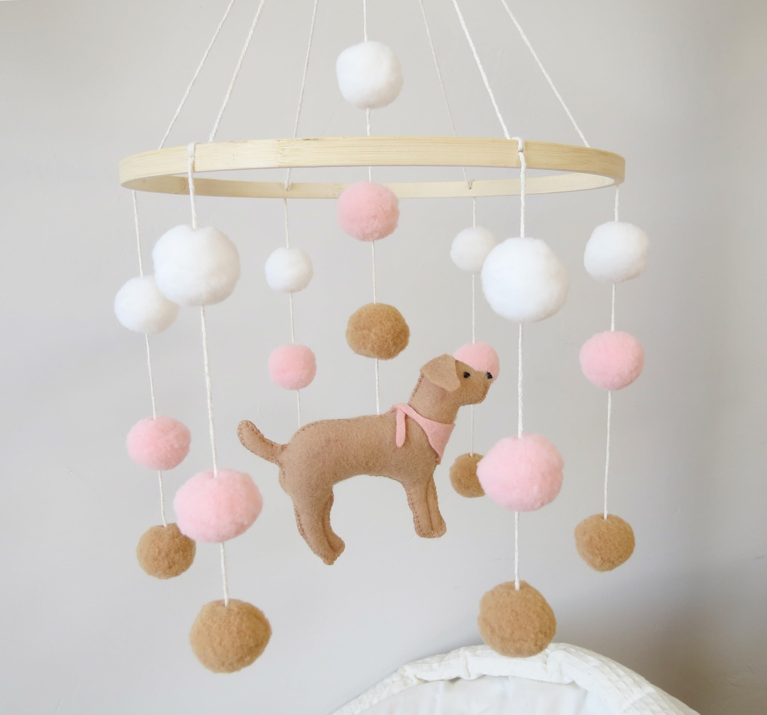 Goukurlsma crib mobile decor featuring dogs adds whimsy.