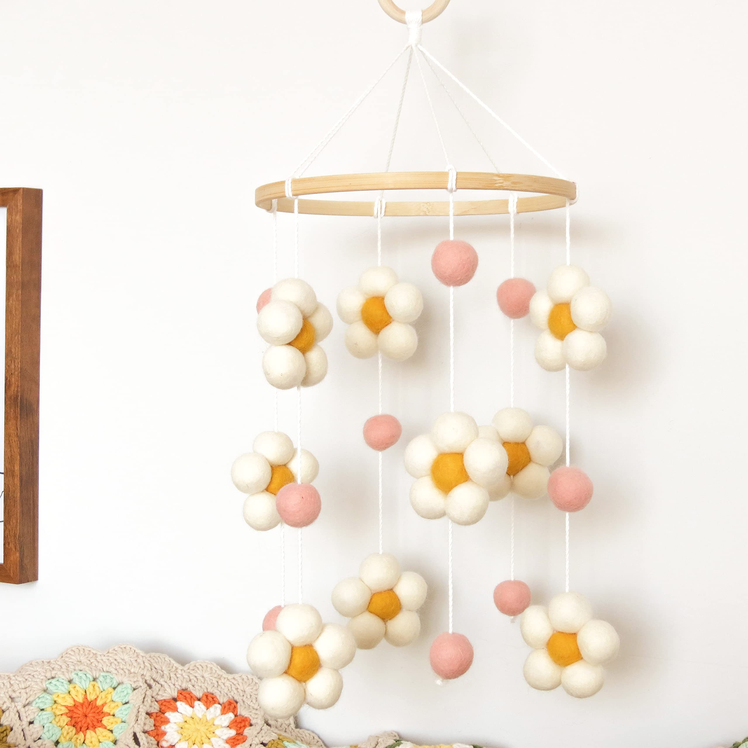 Goukurlsma Daisy Mobile pink felt balls enhance visual stimulation for crib time.