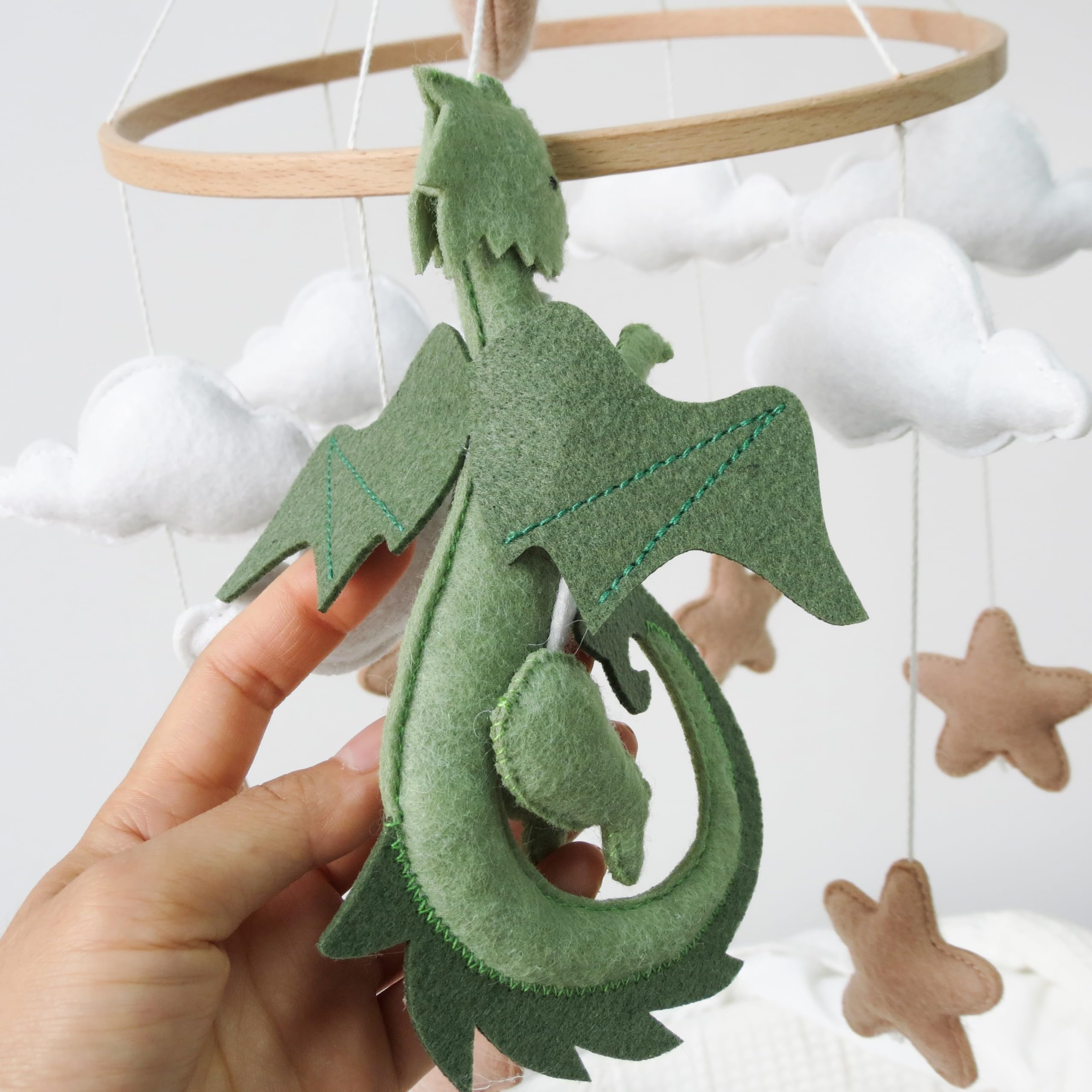 Goukurlsma dragon mobile with green dragons and white clouds creates a calm crib time scene.