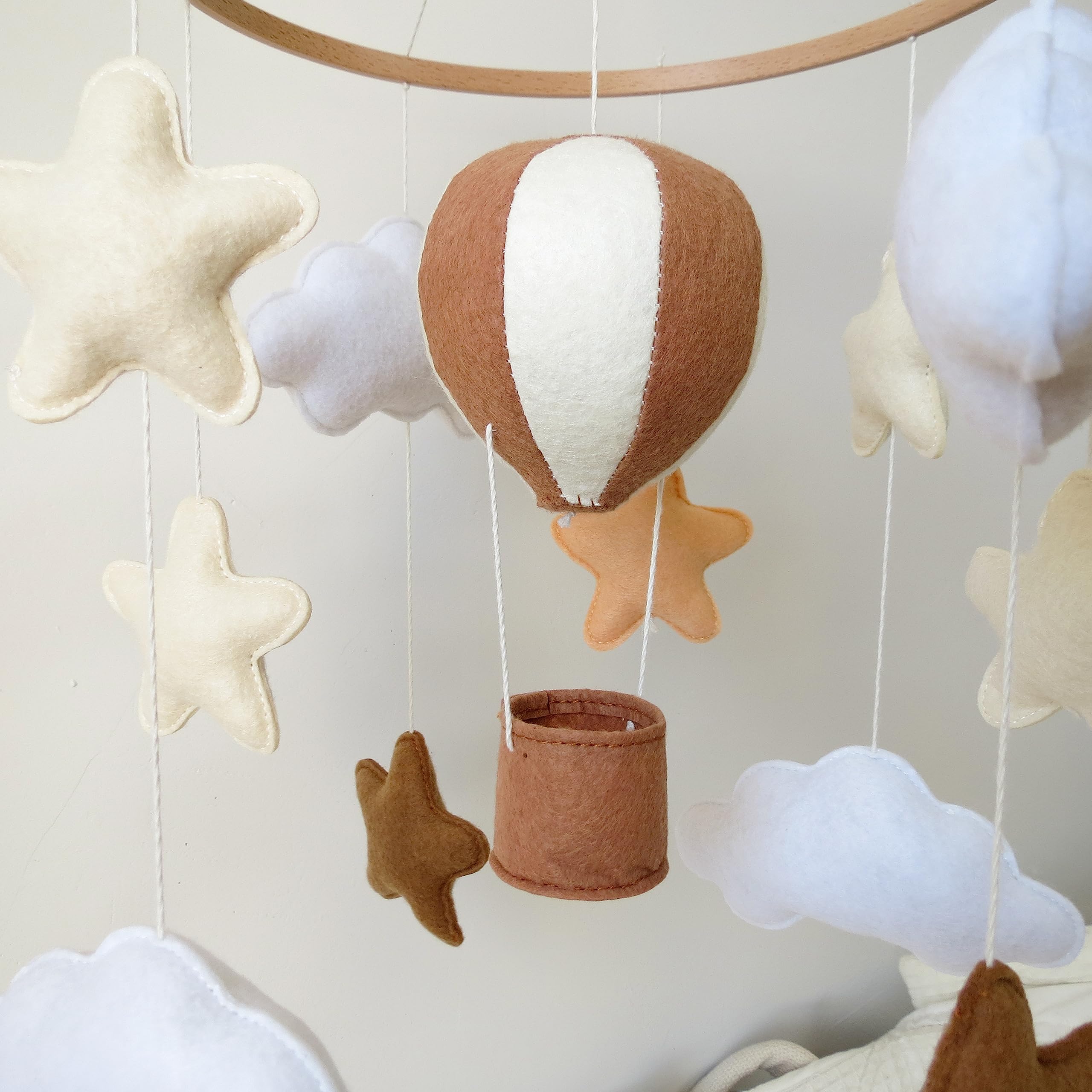 Goukurlsma dyed felt balloons bring warm neutral tones to a Boho nursery.