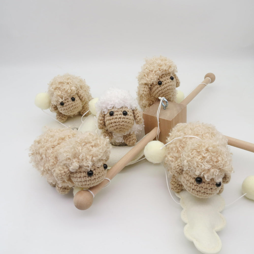 Goukurlsma felt balls add tactile color accents in the crib decor.