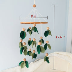 Forest-themed mobile for crib supports early color contrast in baby's view.