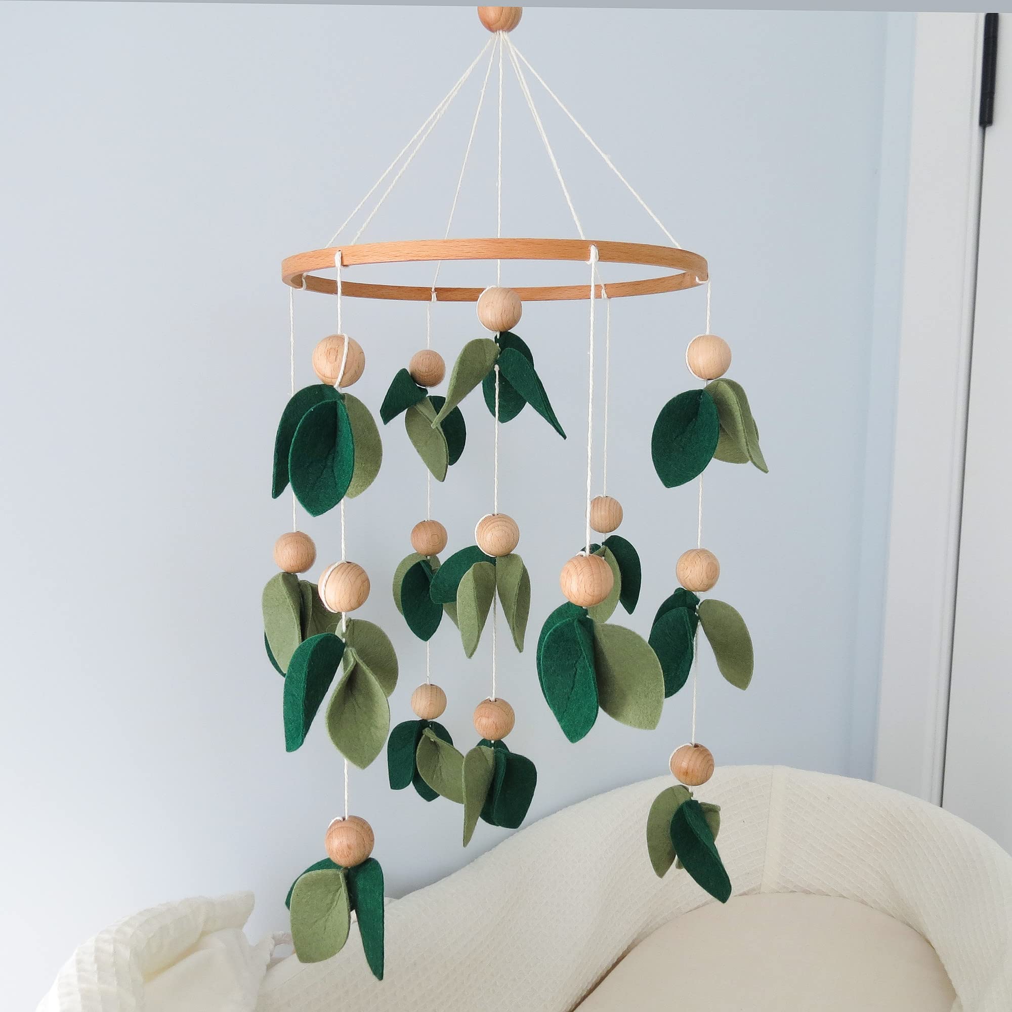 Goukurlsma handmade forest nursery mobile adds natural charm to the crib area.