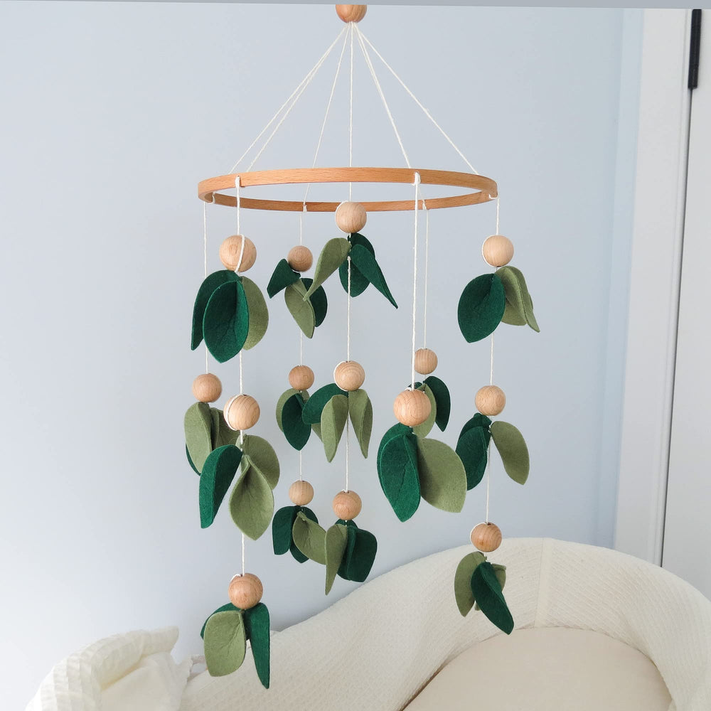 Goukurlsma handmade forest nursery mobile adds natural charm to the crib area.