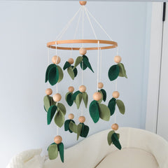 Goukurlsma handmade forest nursery mobile adds natural charm to the crib area.