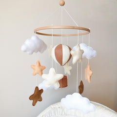 Goukurlsma hot air balloon mobile above crib with beech base for safe visual focus.