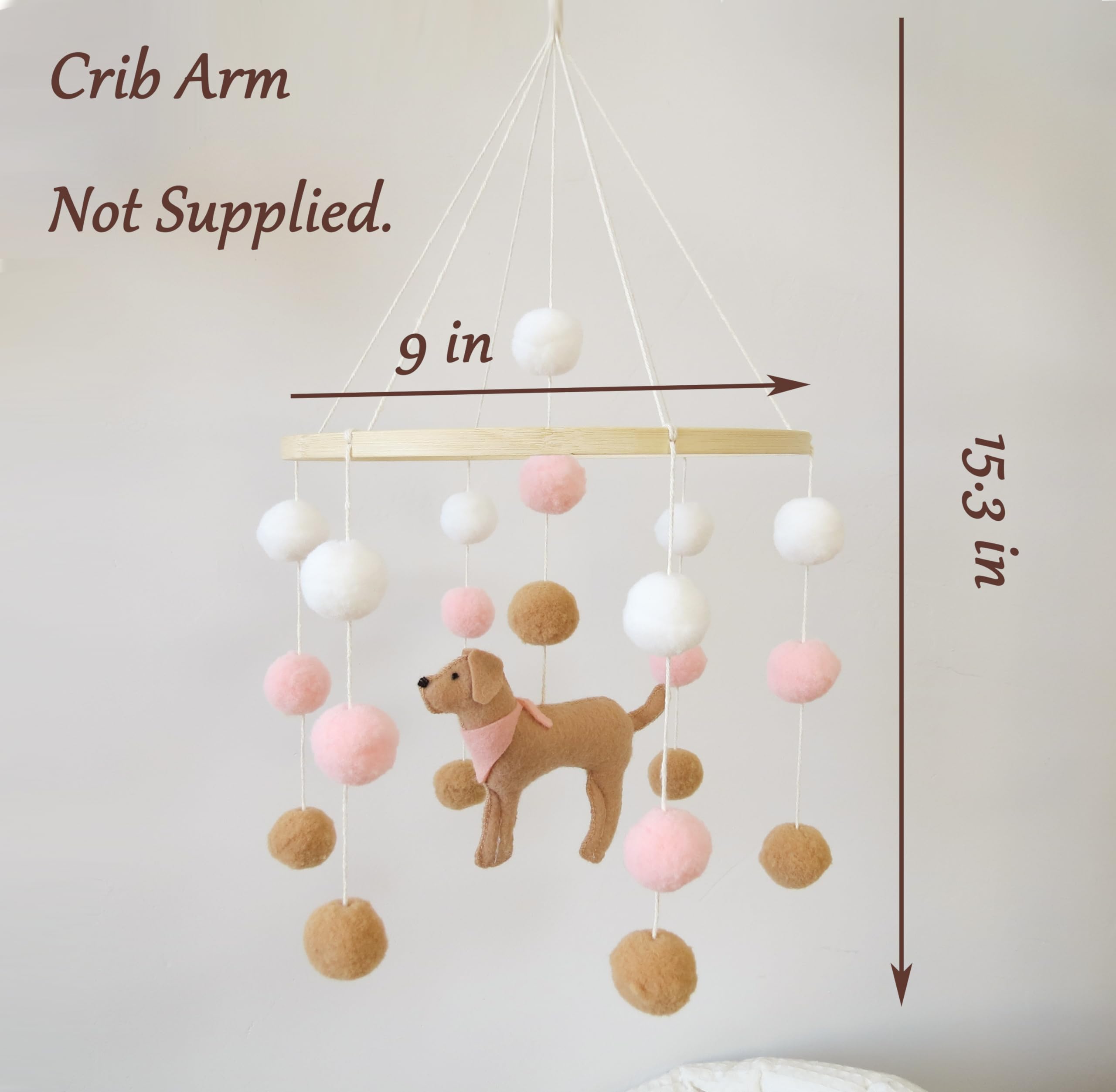 Goukurlsma pink dog-theme mobile above the bassinet adds gentle color.