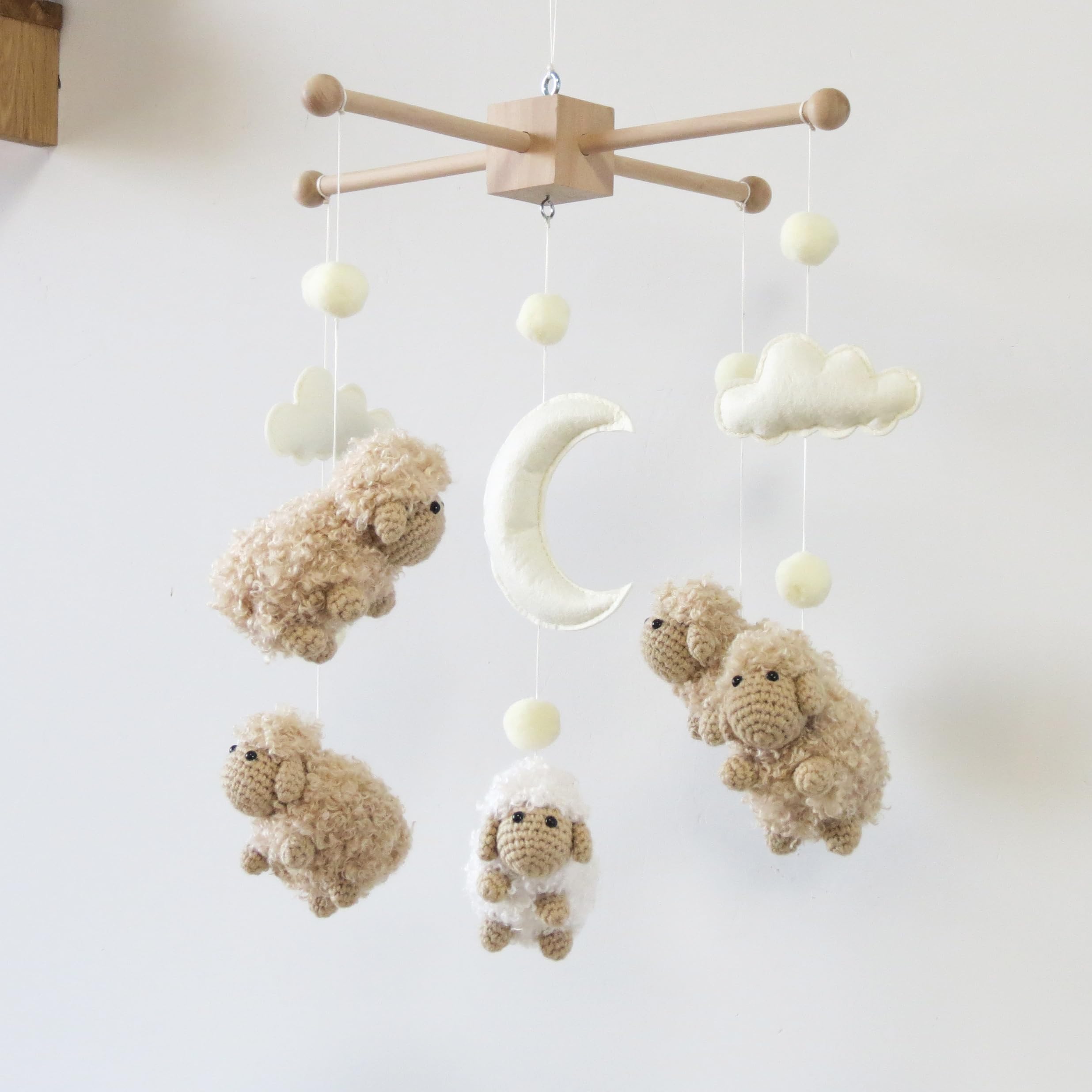 Goukurlsma sheep mobile with wood frame offers a sturdy crib focal point.