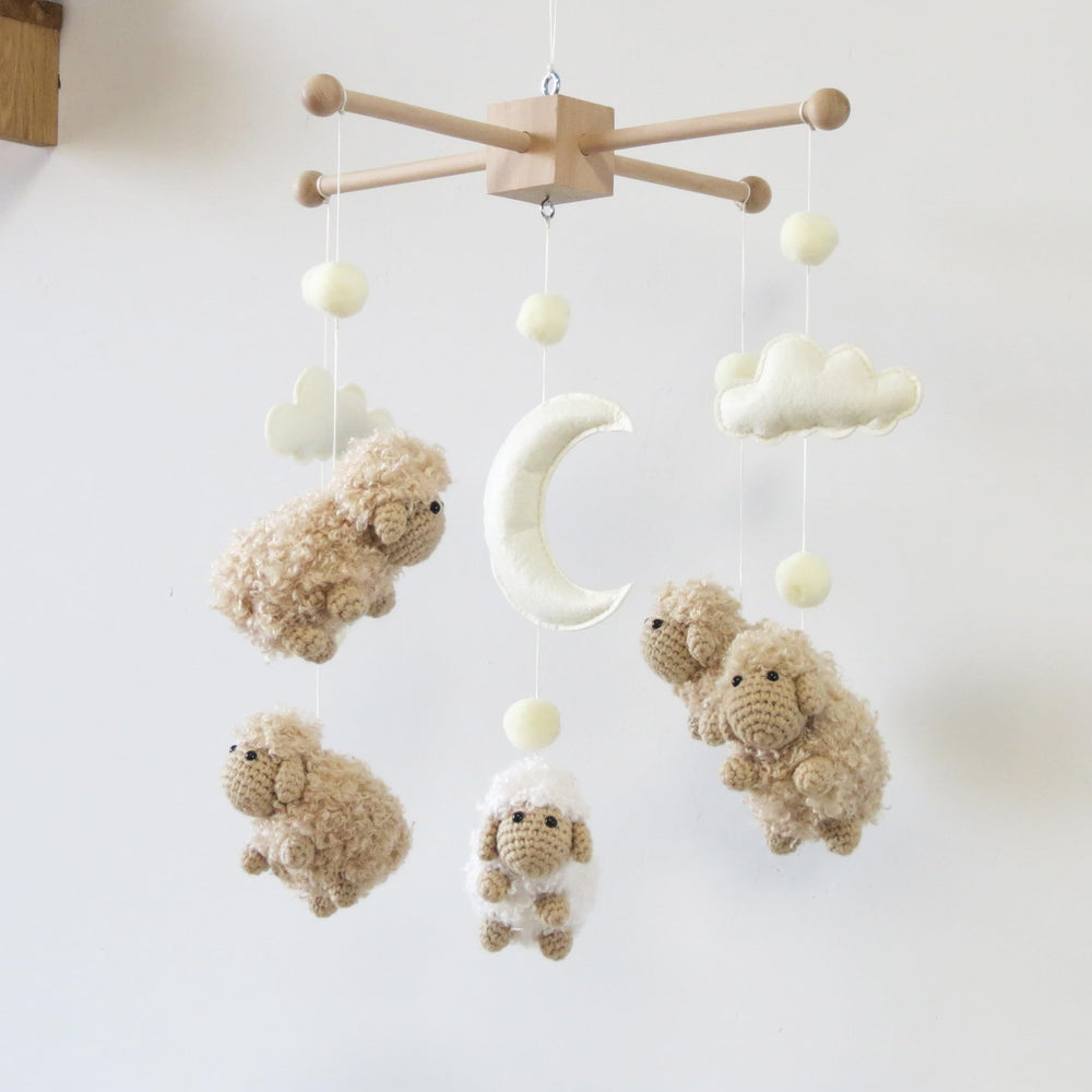 Goukurlsma sheep mobile with wood frame offers a sturdy crib focal point.