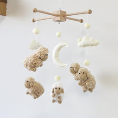 Goukurlsma sheep mobile with wood frame offers a sturdy crib focal point.