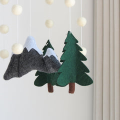 GOUKURLSMA woodland mobile with pine trees enhances visual tracking softly.