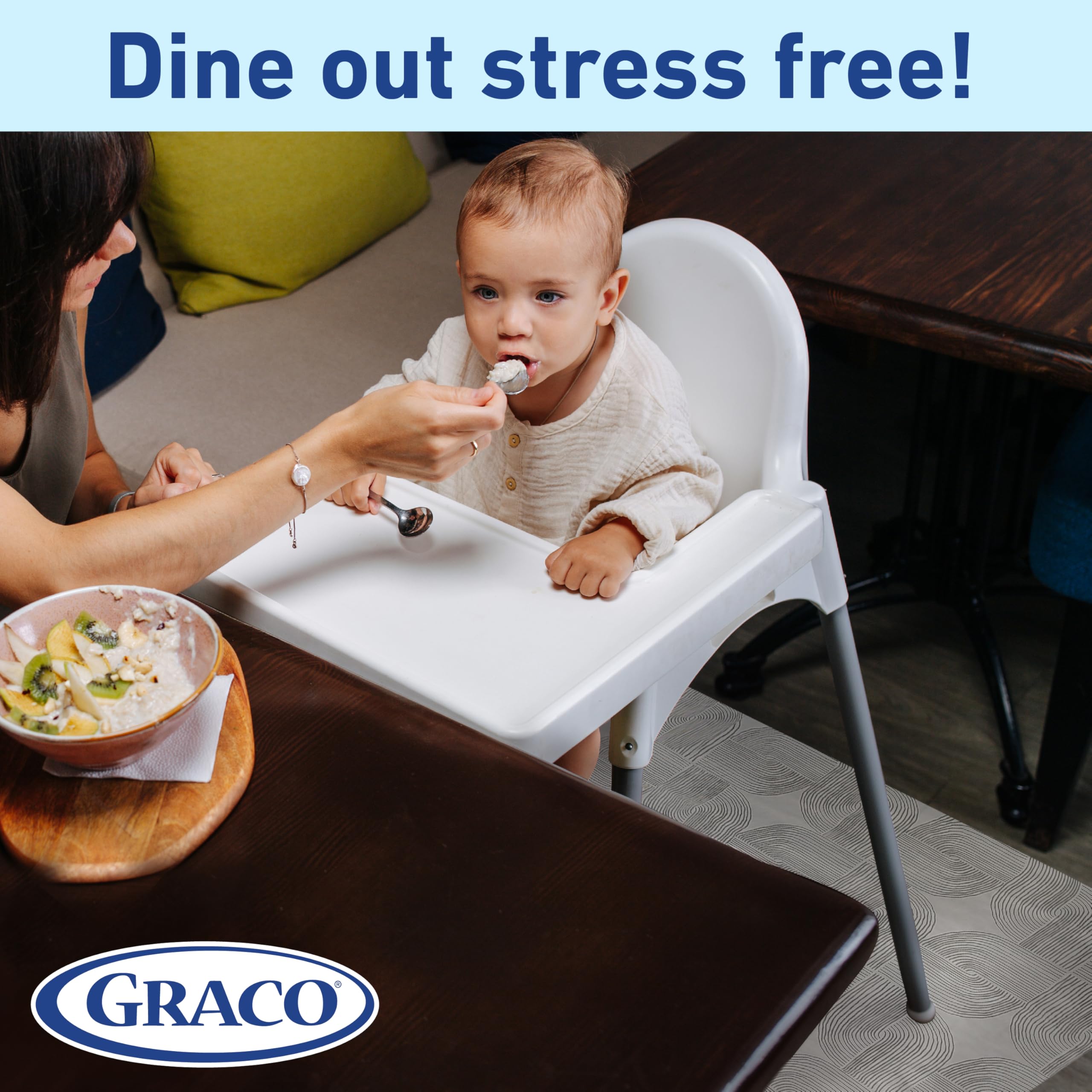 Graco mats spread on a dining floor with a baby nearby.