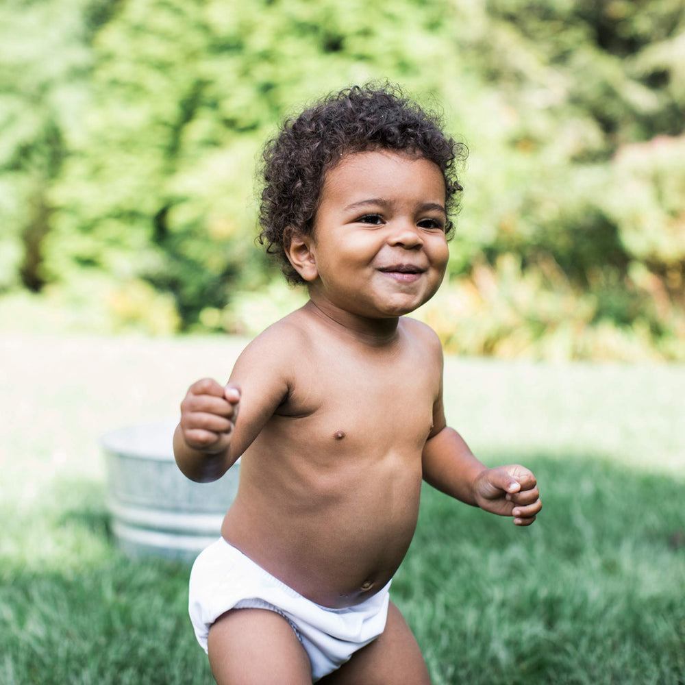 Green Sprouts diaper shows snug waist fit for leak protection.