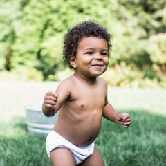 Green Sprouts diaper shows snug waist fit for leak protection.