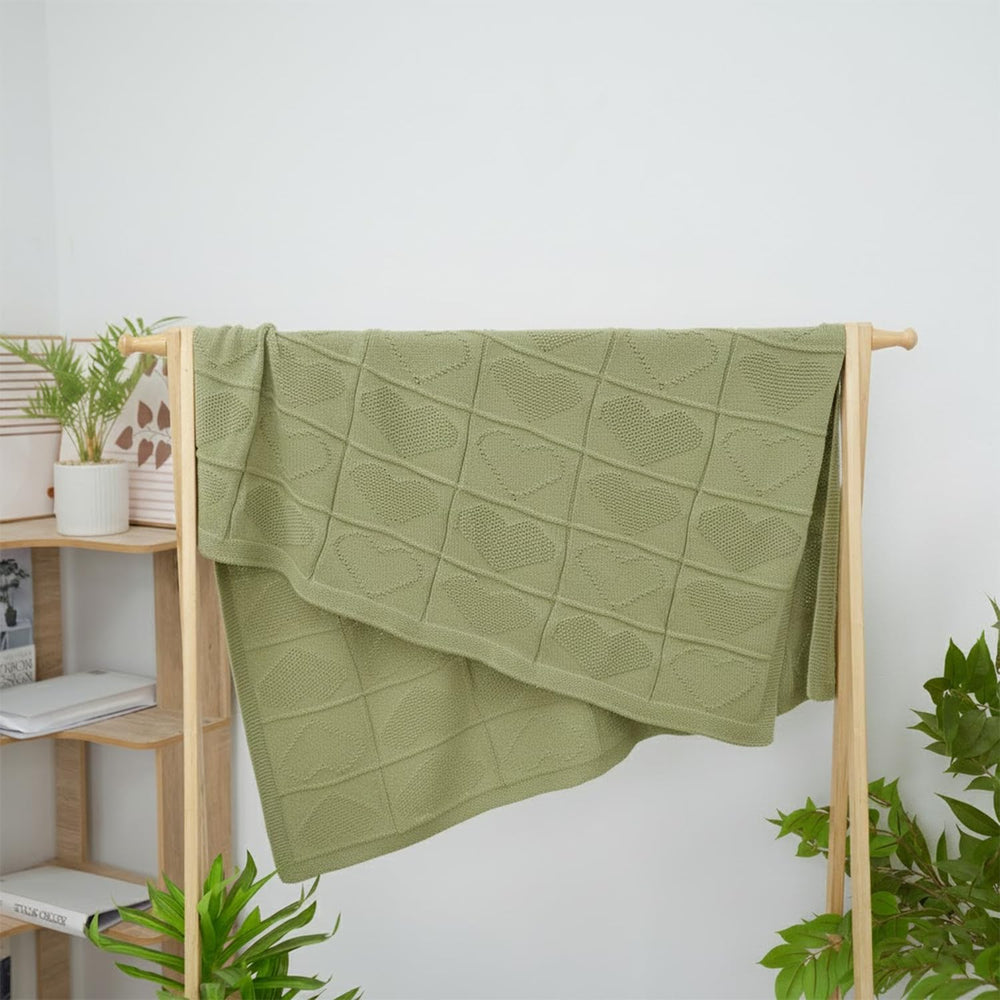 Grewear sage-green blanket complements modern nursery decor.
