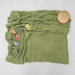 Grewear sage green blanket serves as a gentle swaddle or crib throw for naps.