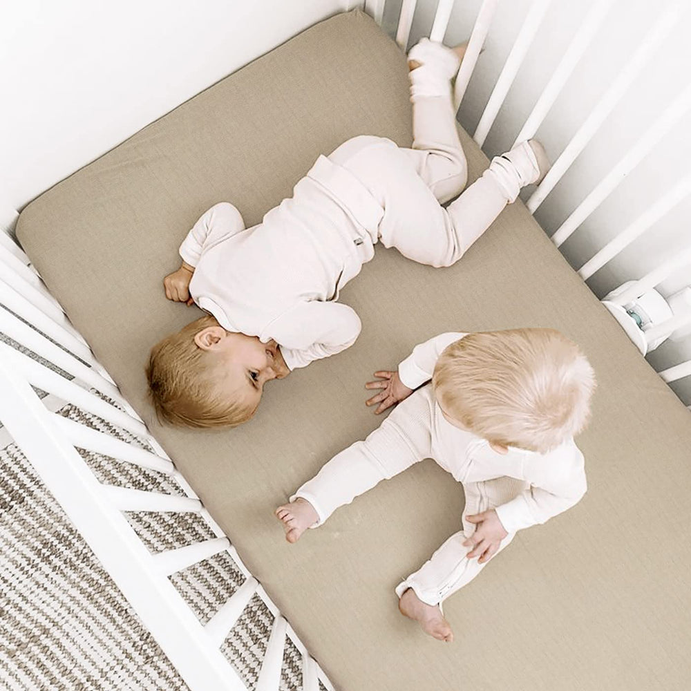 GRSSDER light gray taupe sheet on a standard crib mattress for versatile nursery decor