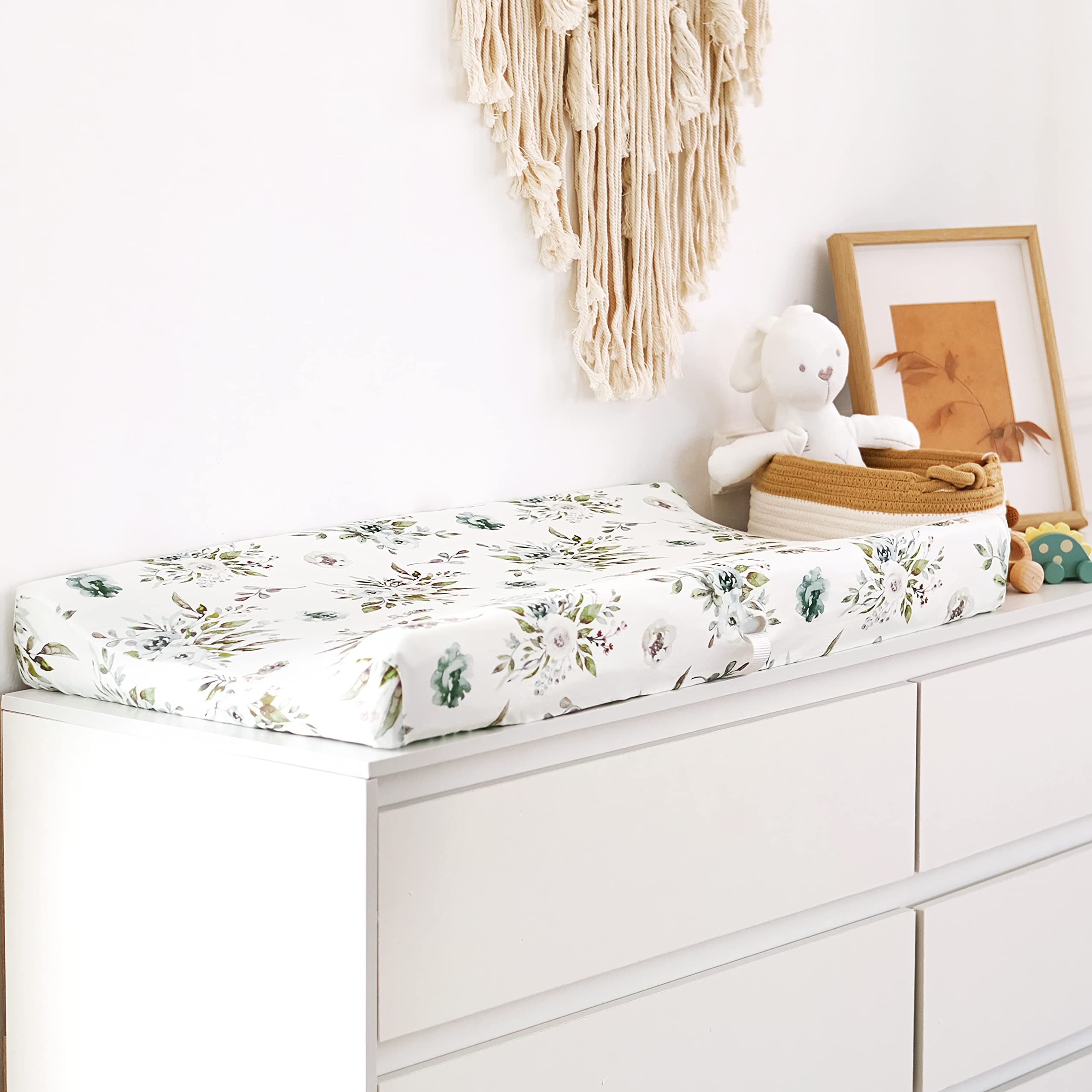 GRSSDER flora-pattern cover adds soft color to nursery during diaper changes.