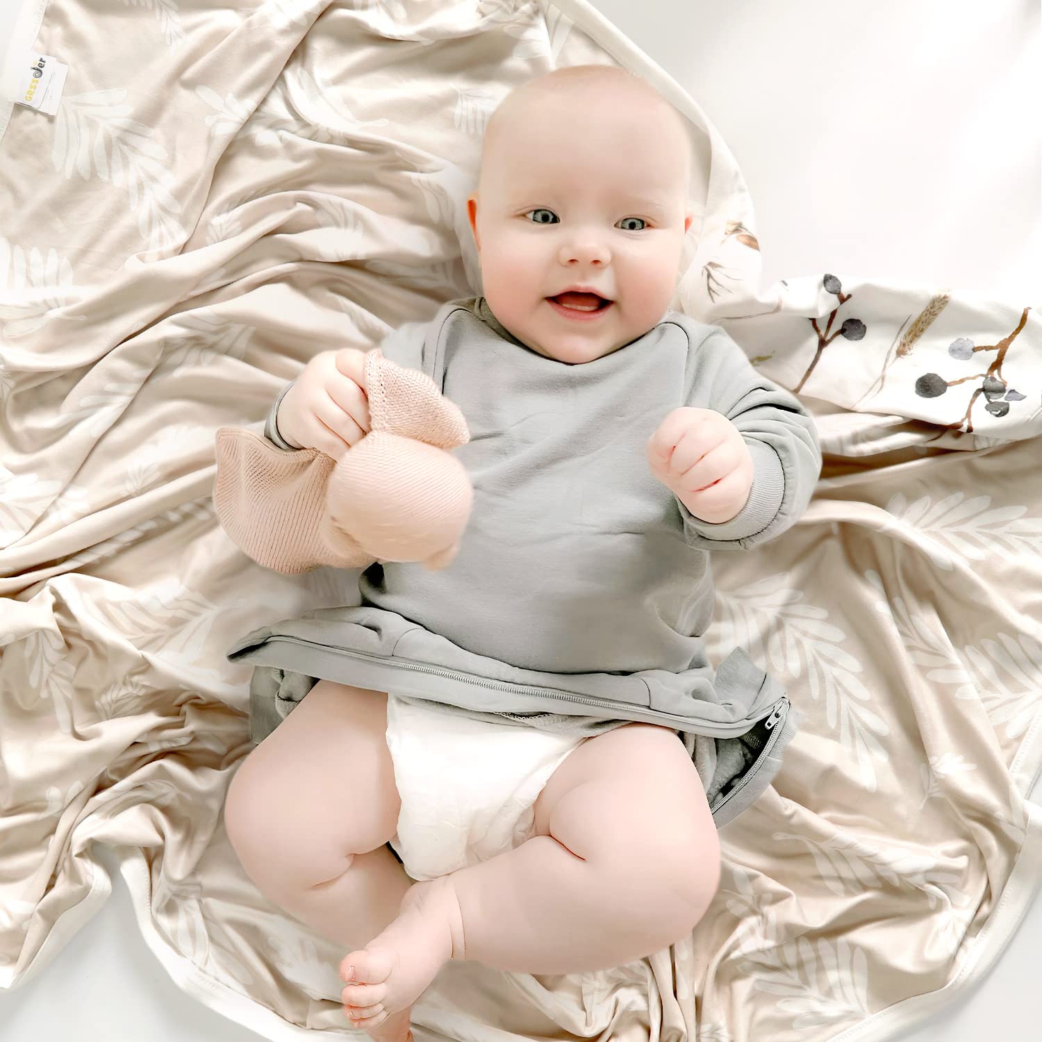 GRSSDER reversible blanket showcases flora design for versatile nursery styling.
