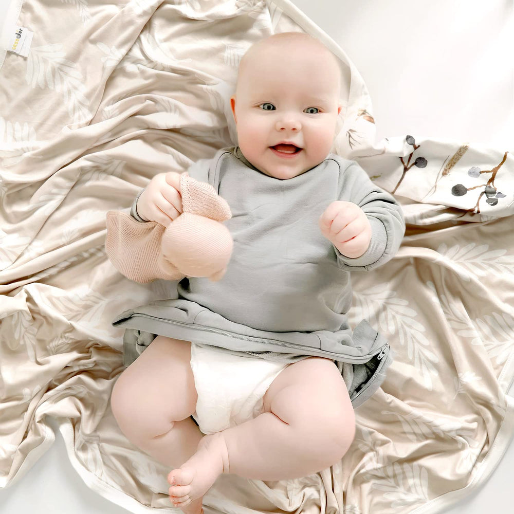 GRSSDER reversible blanket showcases flora design for versatile nursery styling.