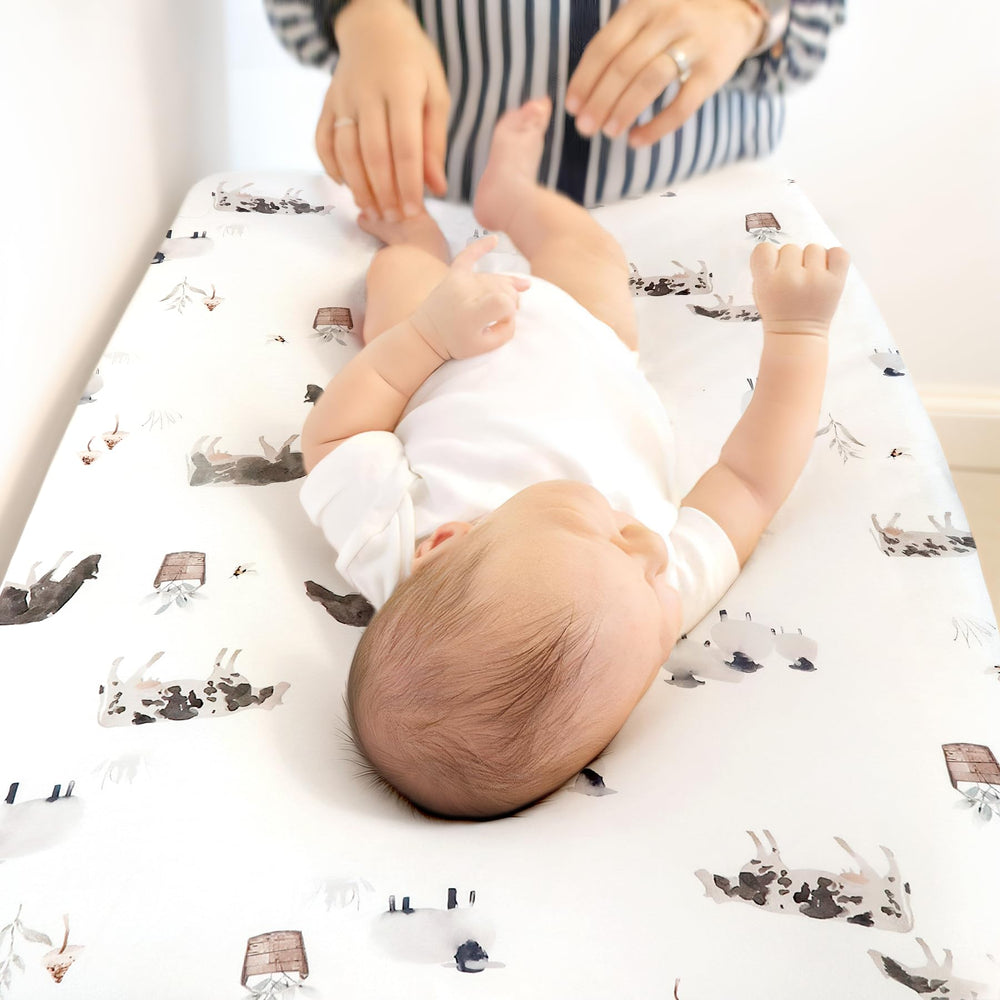 GRSSDER watercolor cows and birds print adds nursery charm during diaper changes.