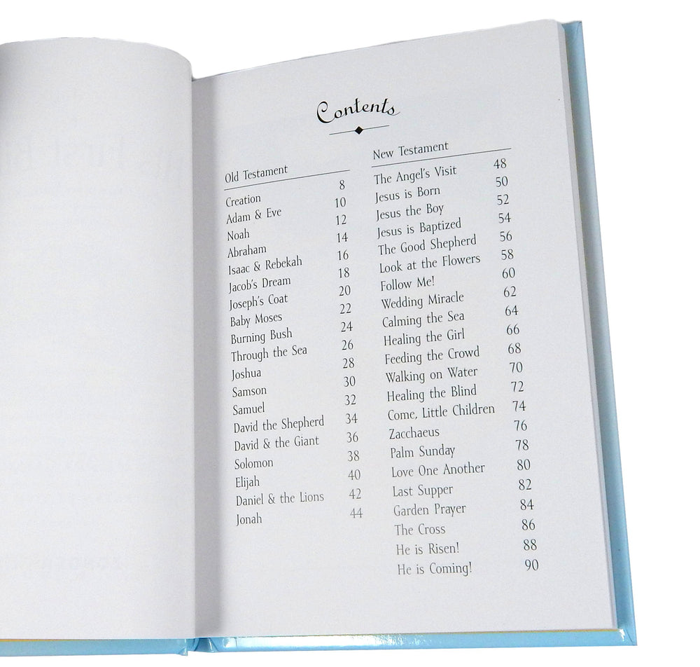 Guardian Angel crib cross in pewter accompanies the baby's first Bible, ideal for christening celebrations.