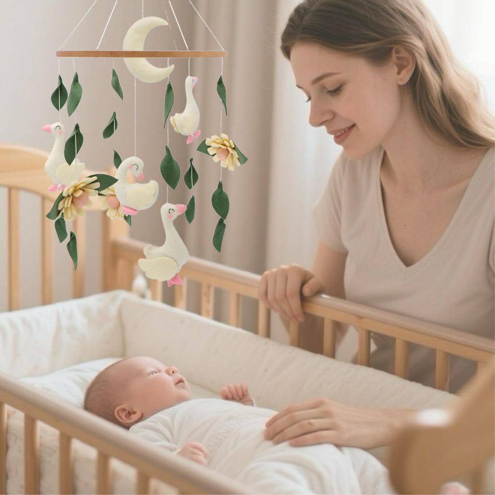 Wood accents on Gueiddi Goose mobile add natural warmth to crib decor