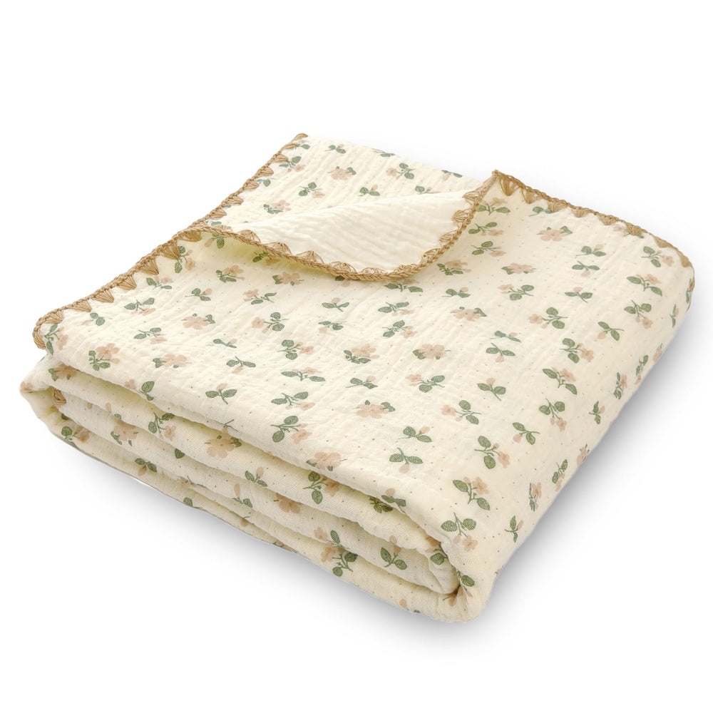Gunnaicat double-layered muslin blanket with flowers print for gentle swaddling and nursery comfort.