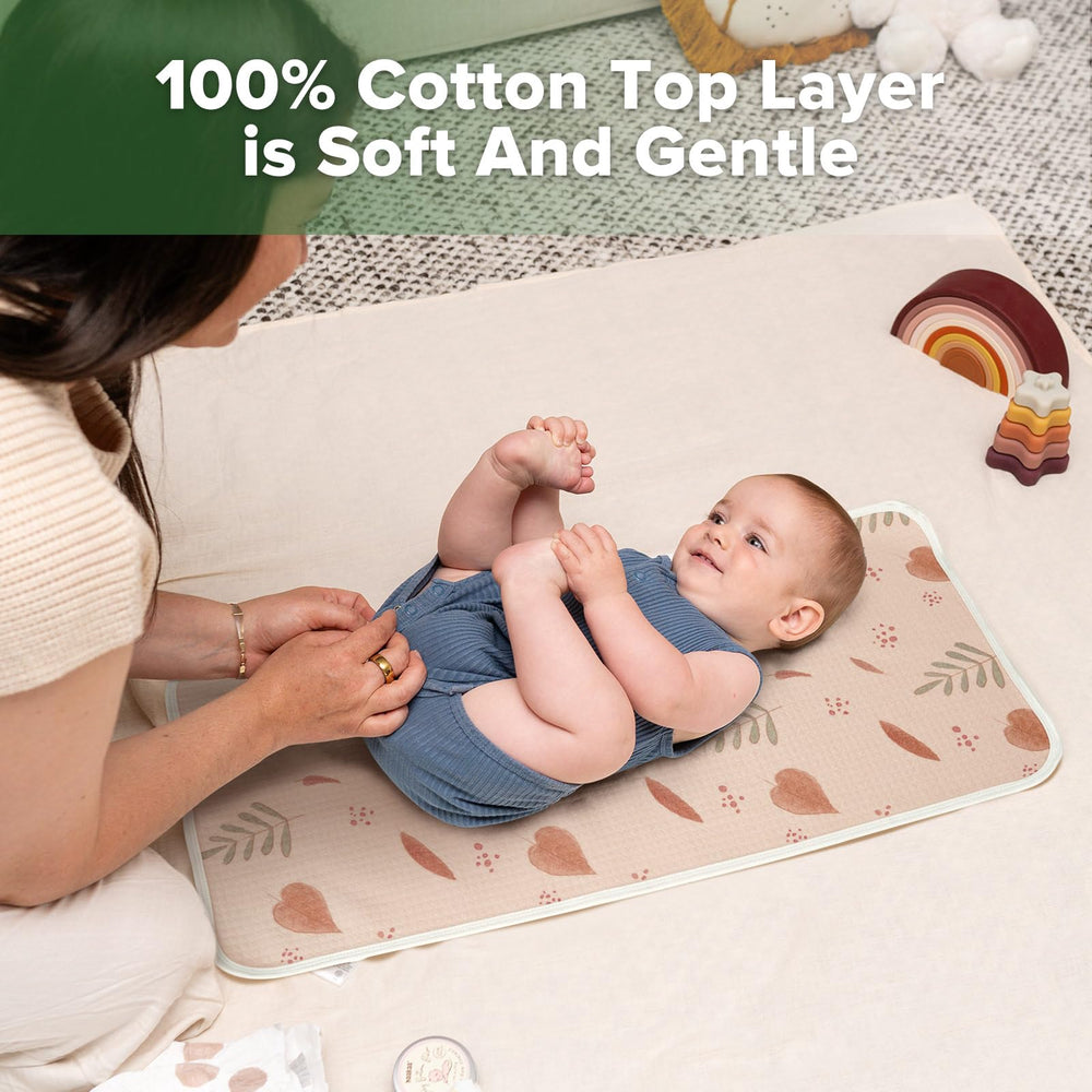Haakaa changing pad liner folded for travel protects surfaces in a diaper bag.