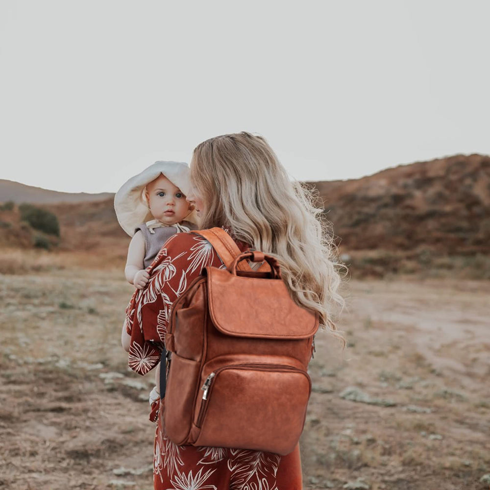 Hahasole leather diaper bag backpack open with changing mat for quick baby item access.