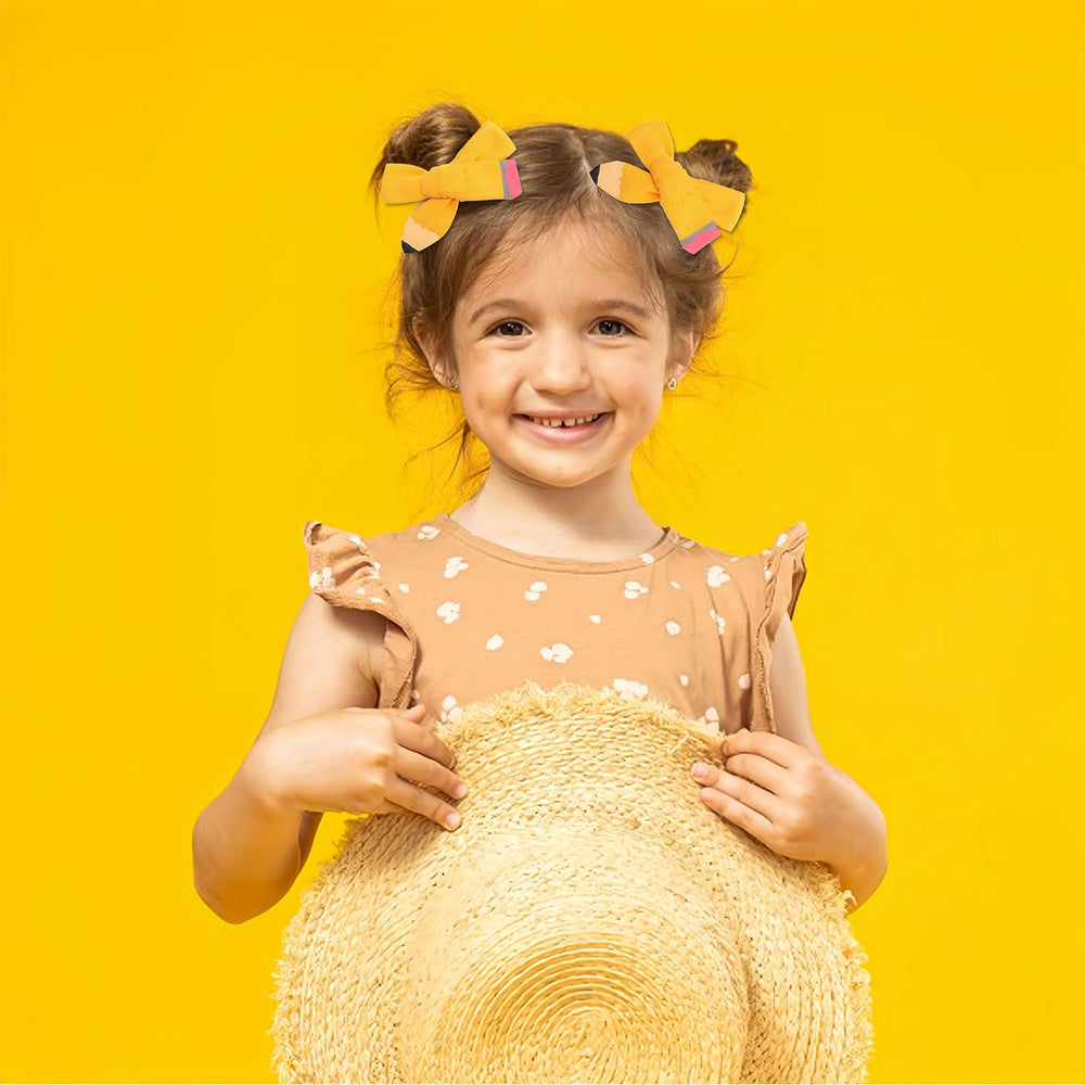 HAIMITI yellow pencil hair bow worn by girl, lightweight hold.
