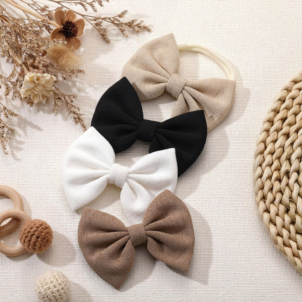 HairChrysm soft baby bow headband in white for clean photo looks.
