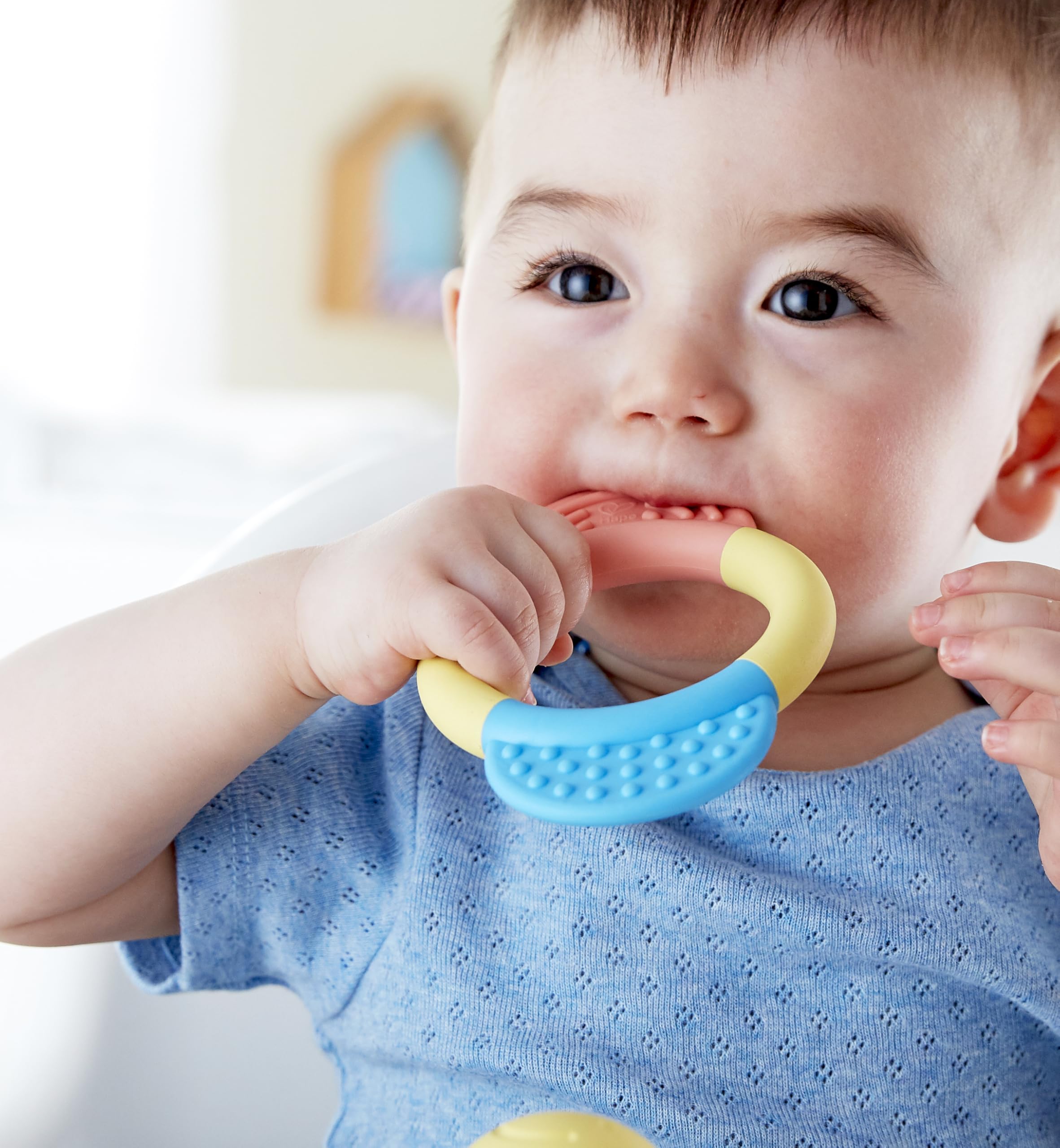 Hape teether ring with multi-textured surfaces for comfort