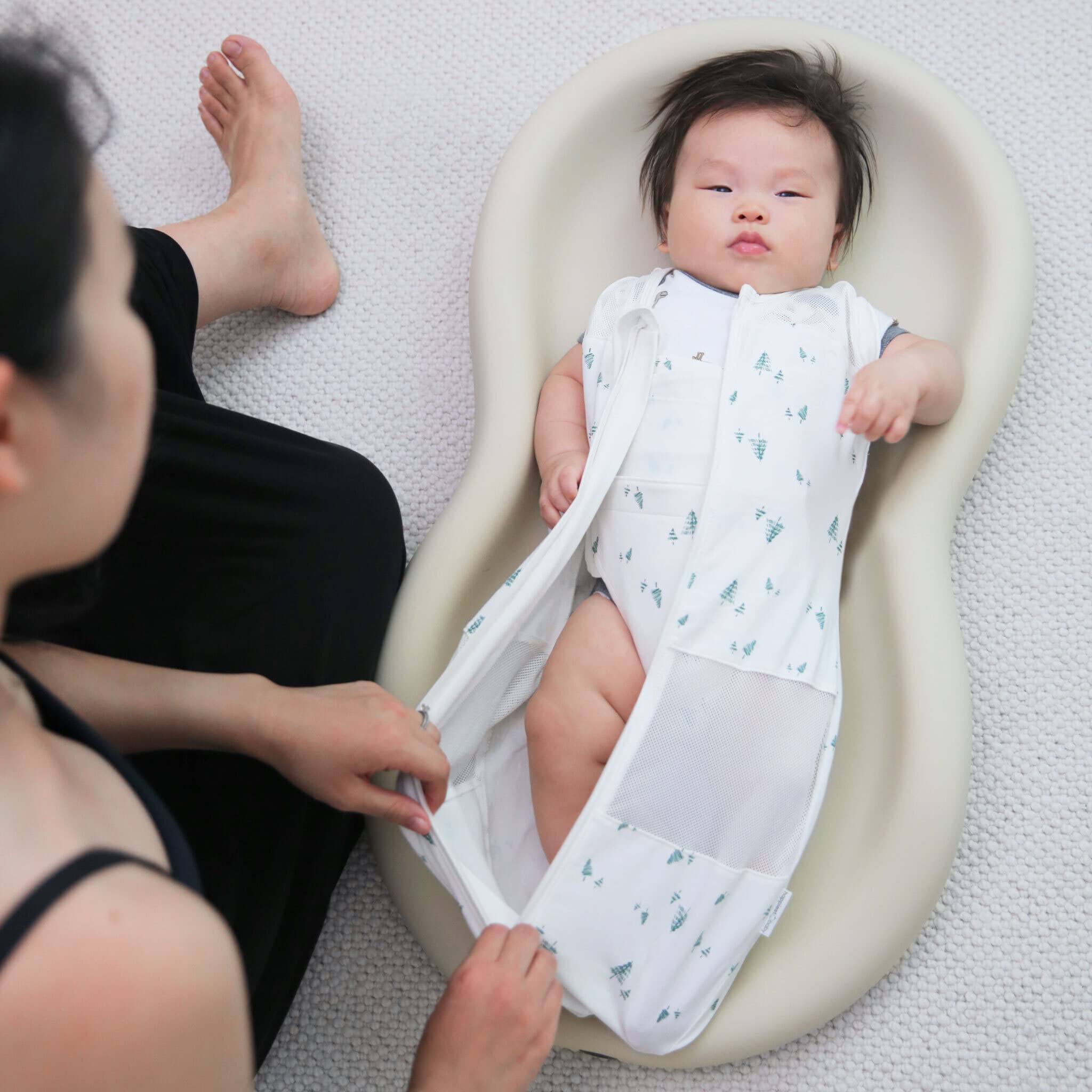 2-way zipper feature demonstrated for easy midnight diaper changes.