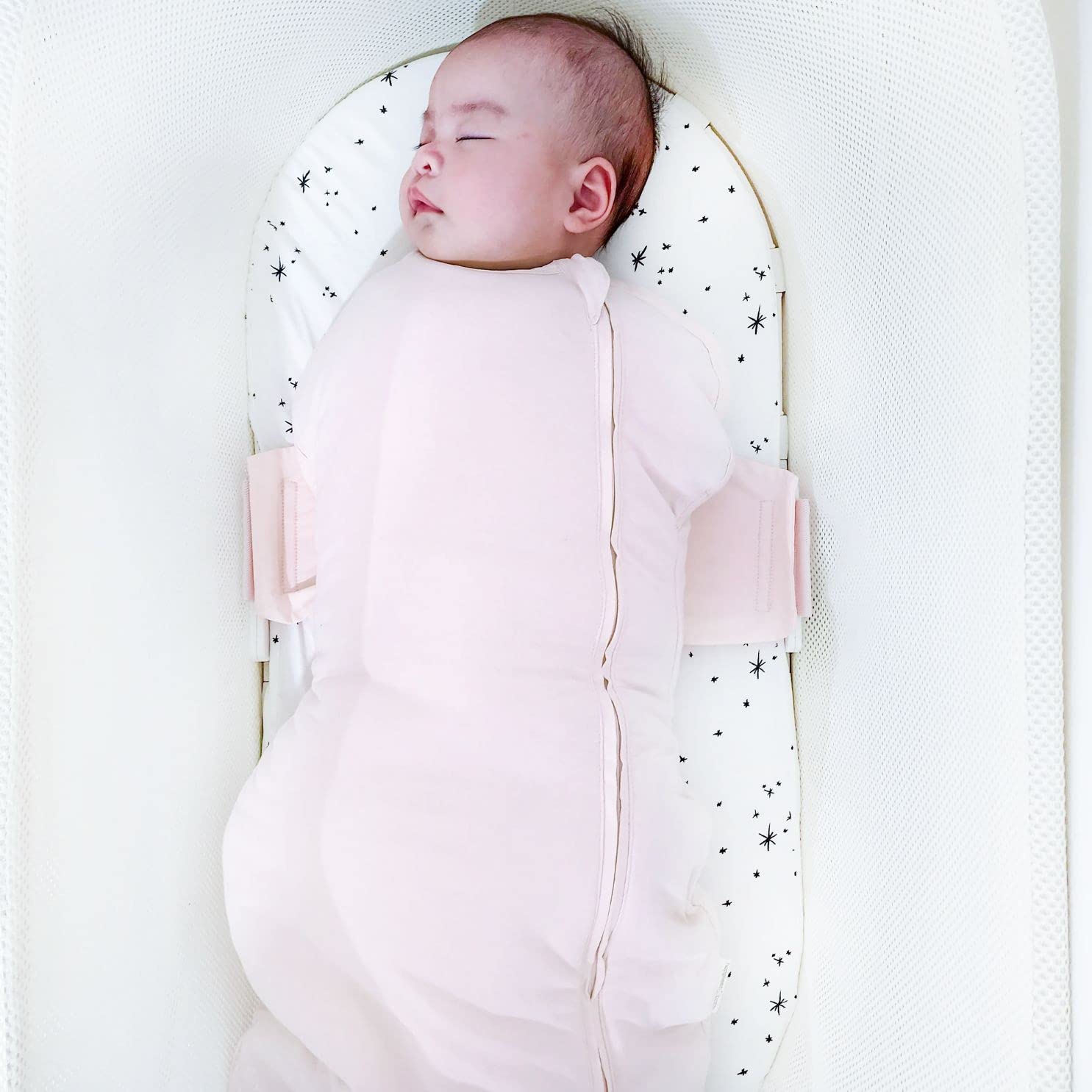 Happiest Baby SNOO Comforter Sack wings cradle baby on back in SNOO.