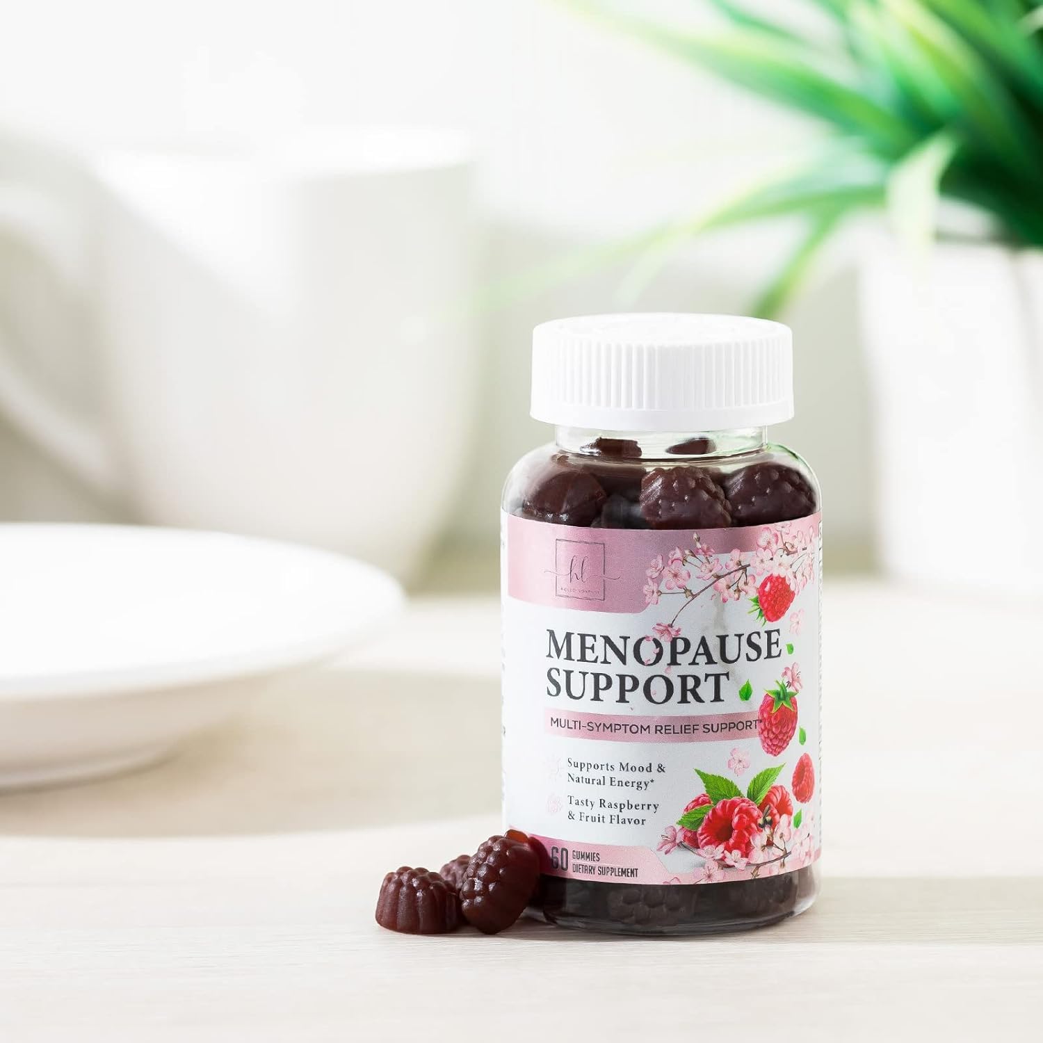 Hello Lovely menopause gummies on teal background evoke raspberry flavor and simple routine.