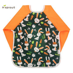 Hi Sprout carrot design bib with pockets catching spills during snack time.