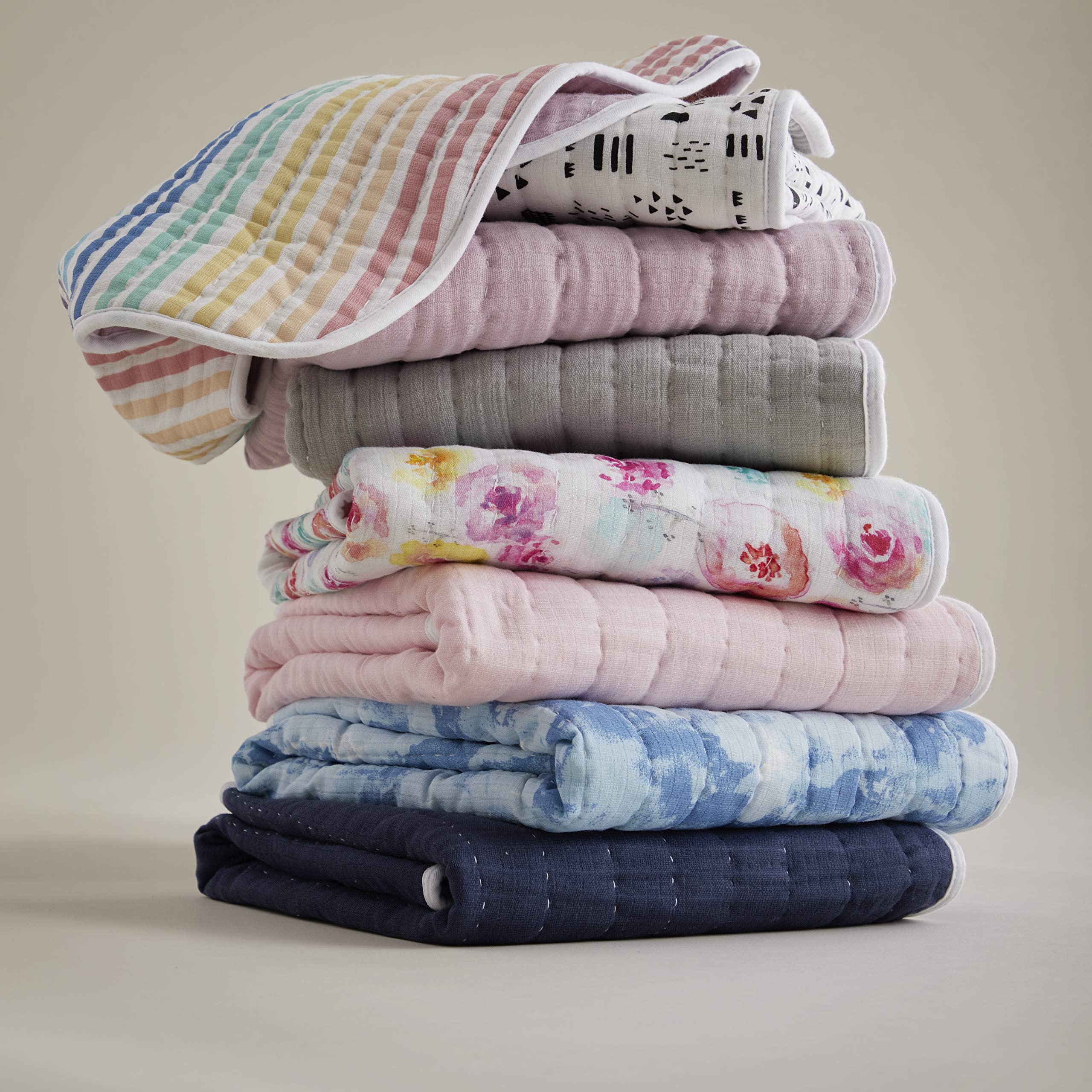 HonestBaby blanket draped over a nursery chair for chic decor styling